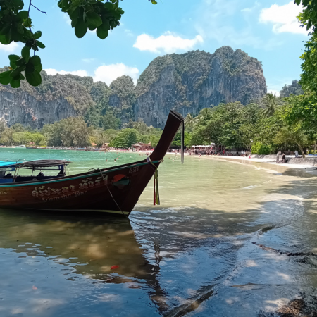 A Longtail boat in the shade at Railay beach