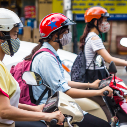 Scooter riders with helmets